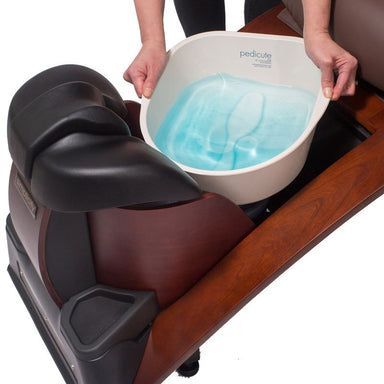 Foot spa with a pedicure bowl containing water on a wooden base of a pipeless pedicure chair