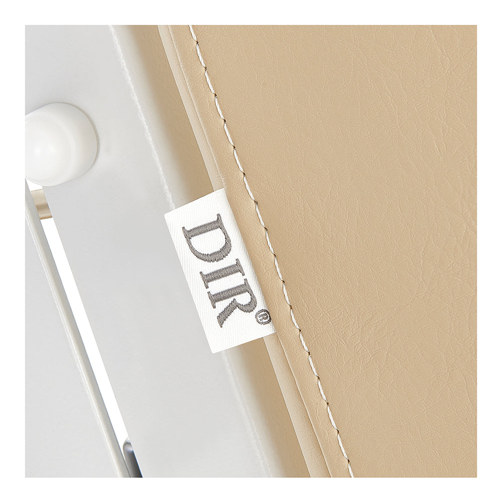 Esthetician chair bed close-up of a beige fabric with a 'DIR' label on 