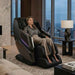 Osaki Titan TP-Epic 4D - Electric Chair Massager - Woman relaxing indoor view