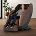 Osaki Ziva - Electric Chair Massager - Woman relaxing in brown chain in indoor setting