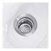 Stainless steel sink drain with vacuum breaker for white ceramic shampoo bowl on salon station